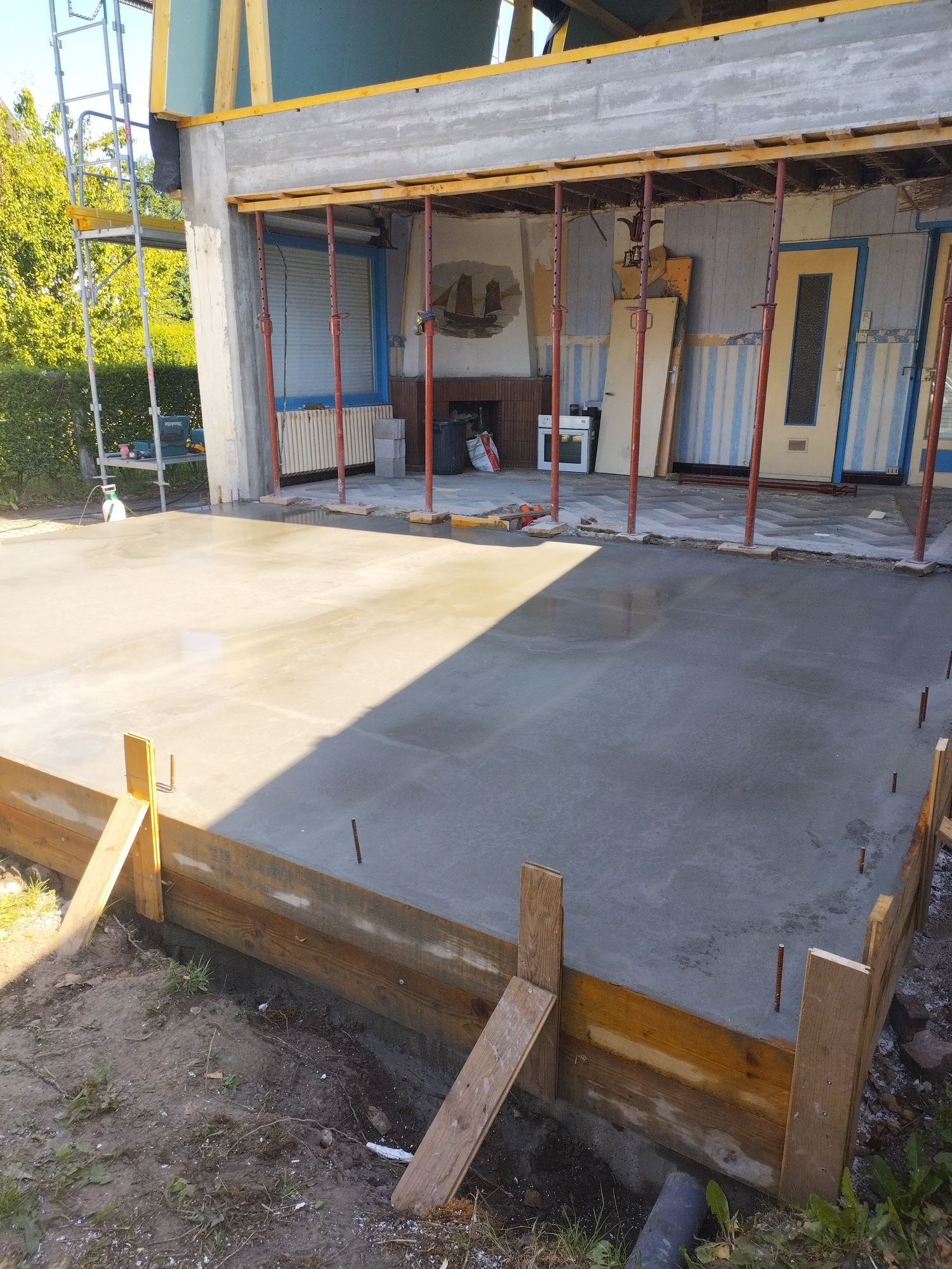 Étaler du béton frais à la truelle sur un mur en parpaings lors de travaux de maçonnerie