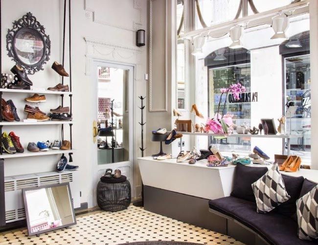 Una zapatería con un sofá y un espejo