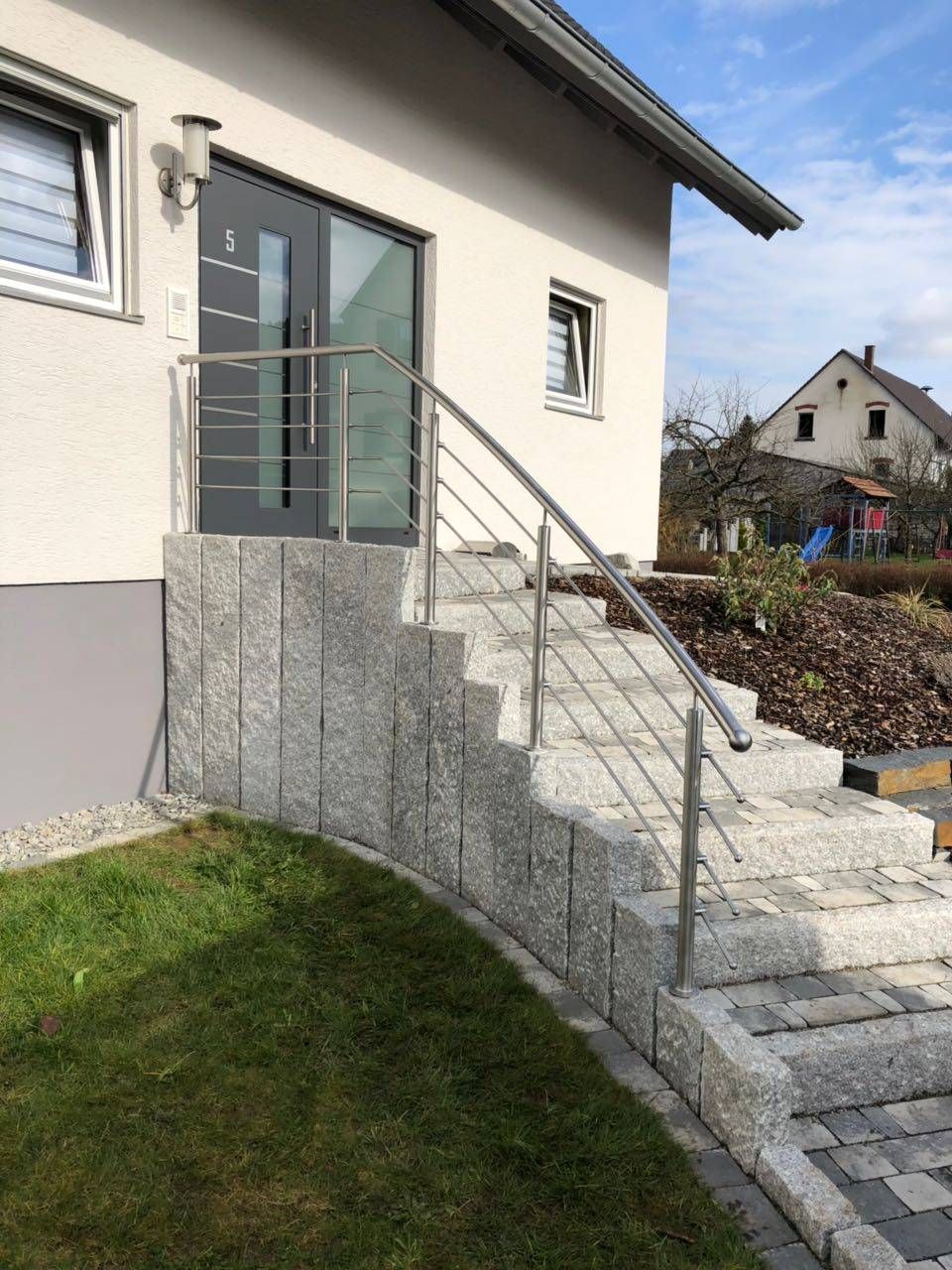 ein Haus mit Treppen und einem Geländer aus Edelstahl