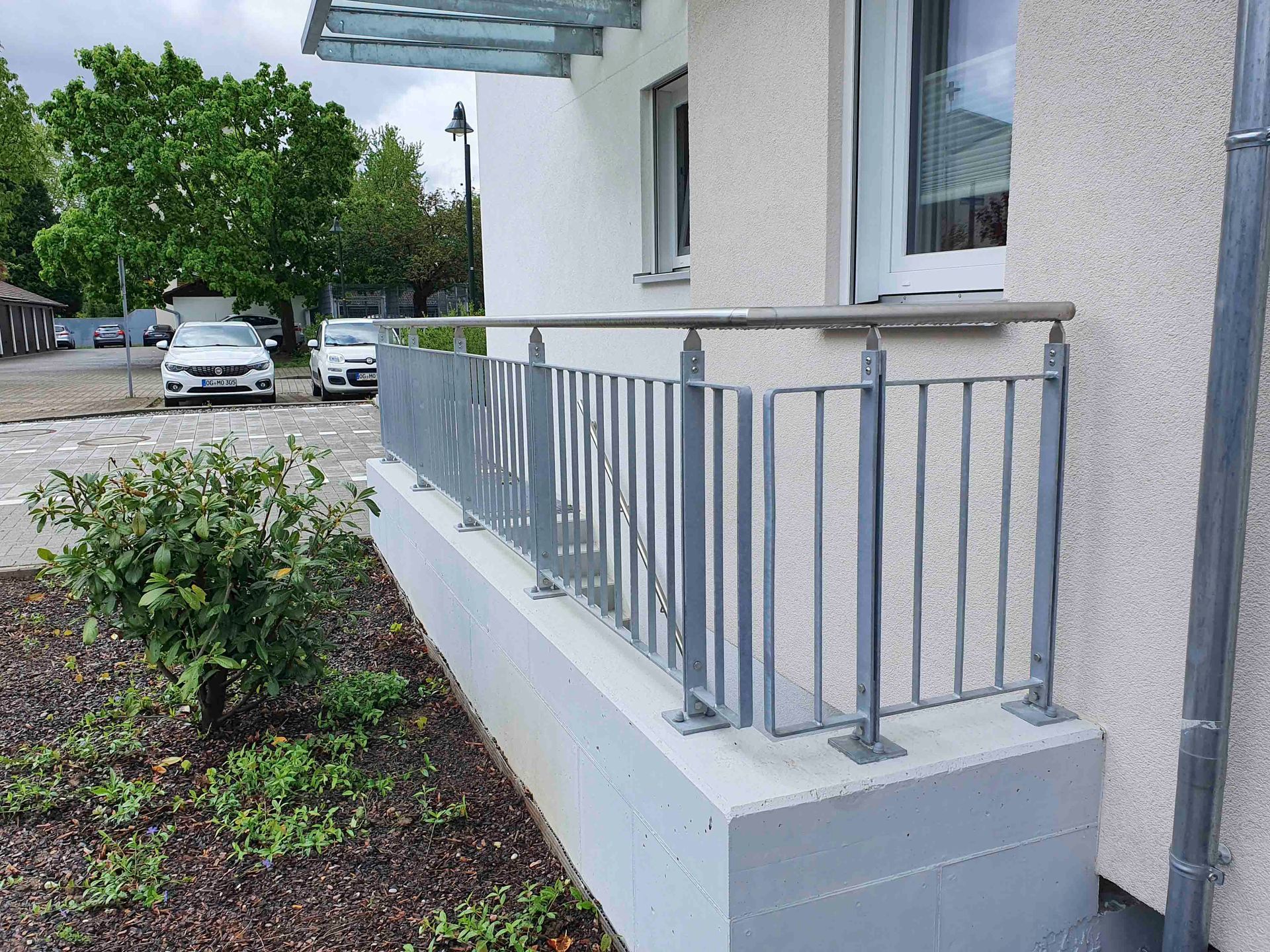 ein Balkon mit einem Metallgeländer an der Seite eines Gebäudes