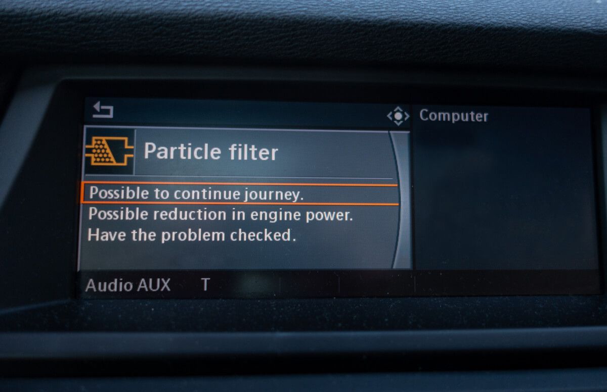A car dashboard with a screen that says particle filter