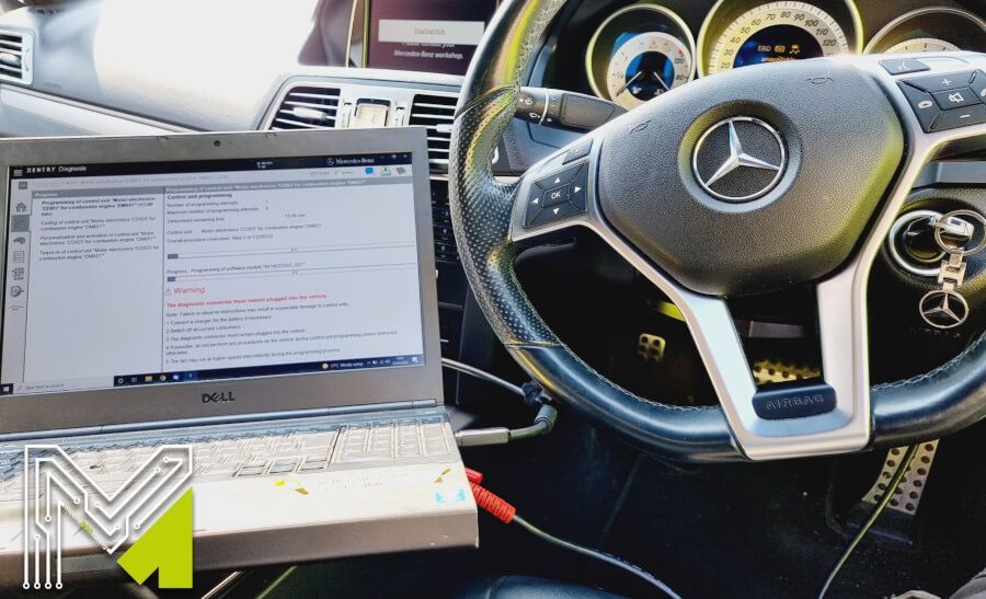 A laptop is sitting in the driver 's seat of a mercedes