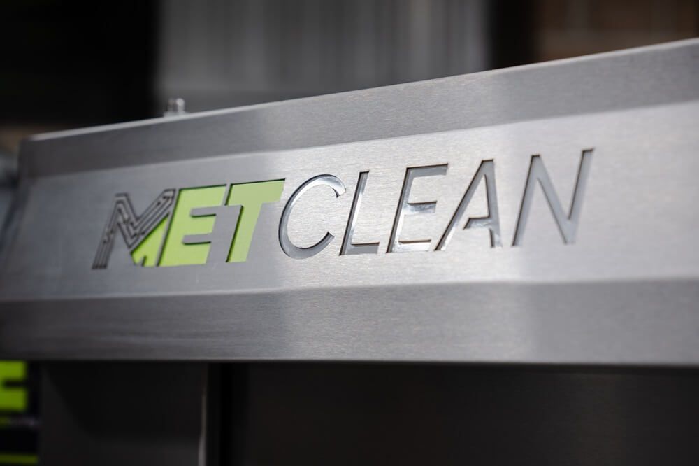 A metal sign that says metclean on it