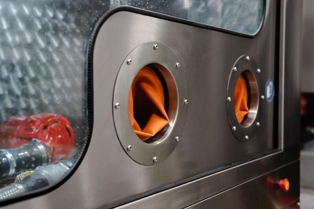 A close up of a stainless steel machine with two holes in it.