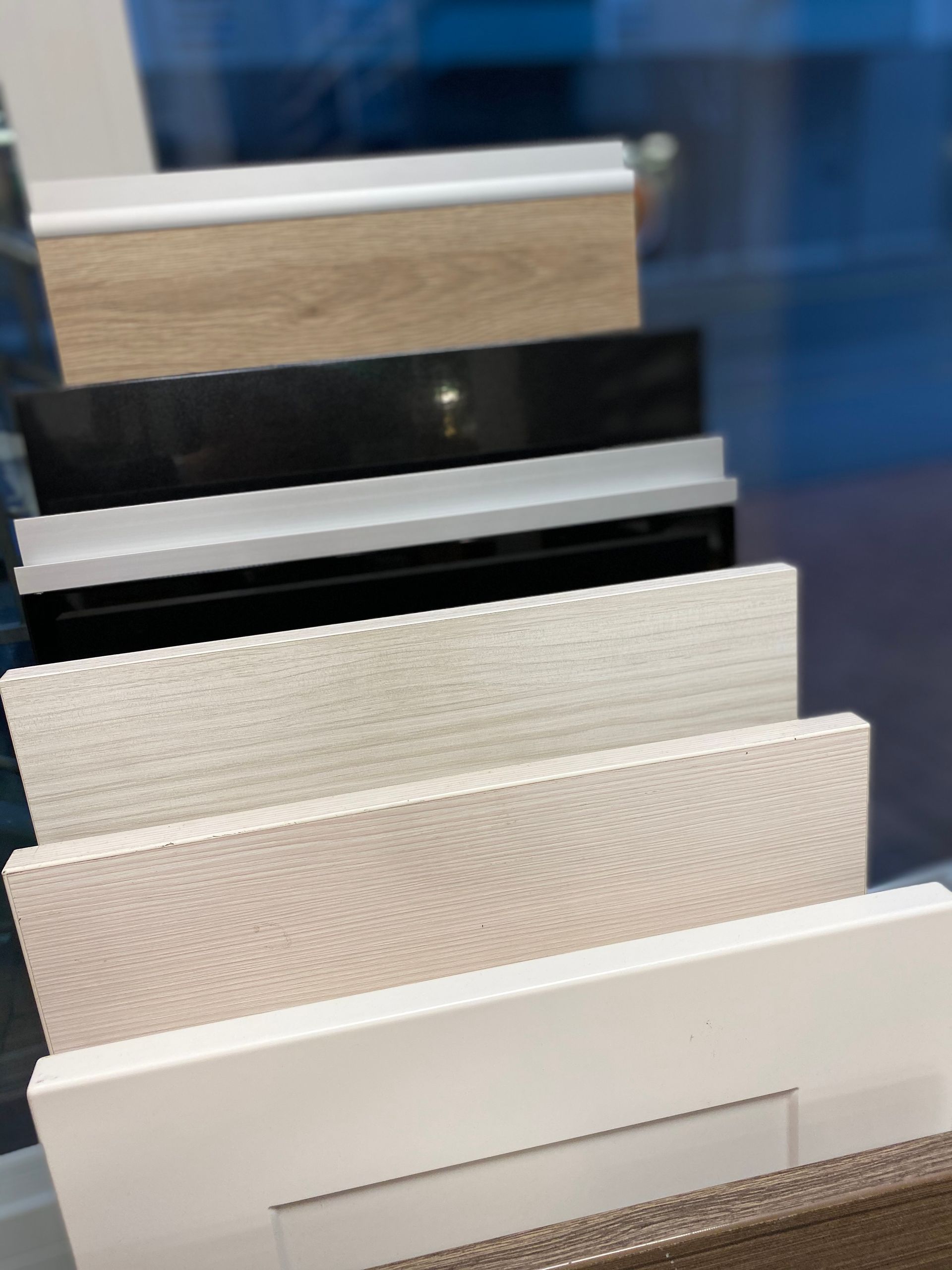 Näyttelyssä esillä olevia kaapin ovien näytteitä eri väreissä ja viimeistelyissä.