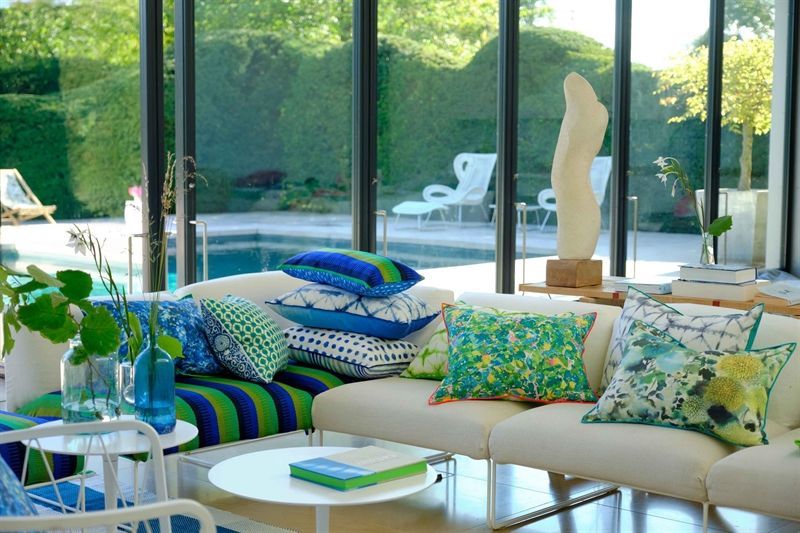 Ein Wohnzimmer mit einer Couch und vielen bunten Kissen