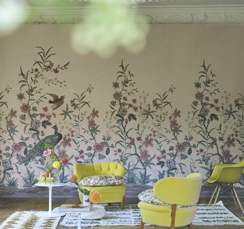 Ein Wohnzimmer mit gelben Stühlen und einer geblümten Tapete