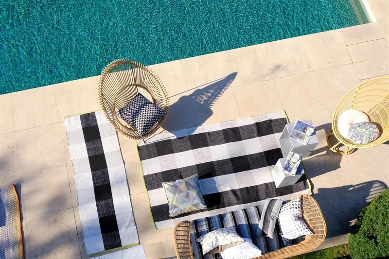 Eine Luftaufnahme eines Swimmingpools, umgeben von Gartenmöbeln