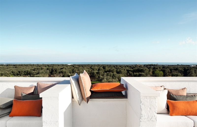 Ein Balkon mit Blick auf das Meer und die Bäume