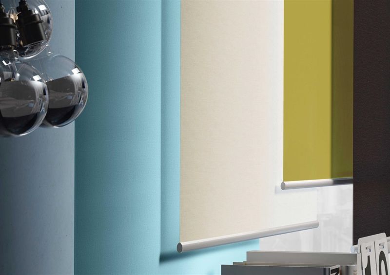 Eine Reihe verschiedenfarbiger Jalousien hängt an einer Wand