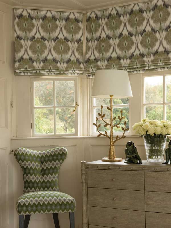 Ein Raum mit einem Stuhl, einer Lampe und einer Vase mit Blumen