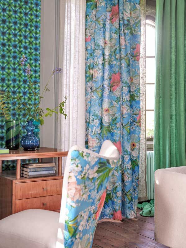 Ein Zimmer mit blauen Vorhängen und grünen Vorhängen