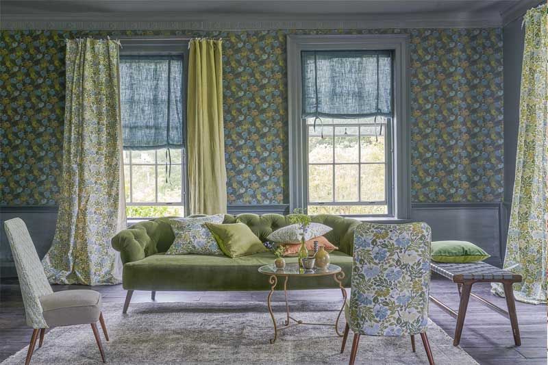 Ein Wohnzimmer mit einer grünen Couch und Stühlen