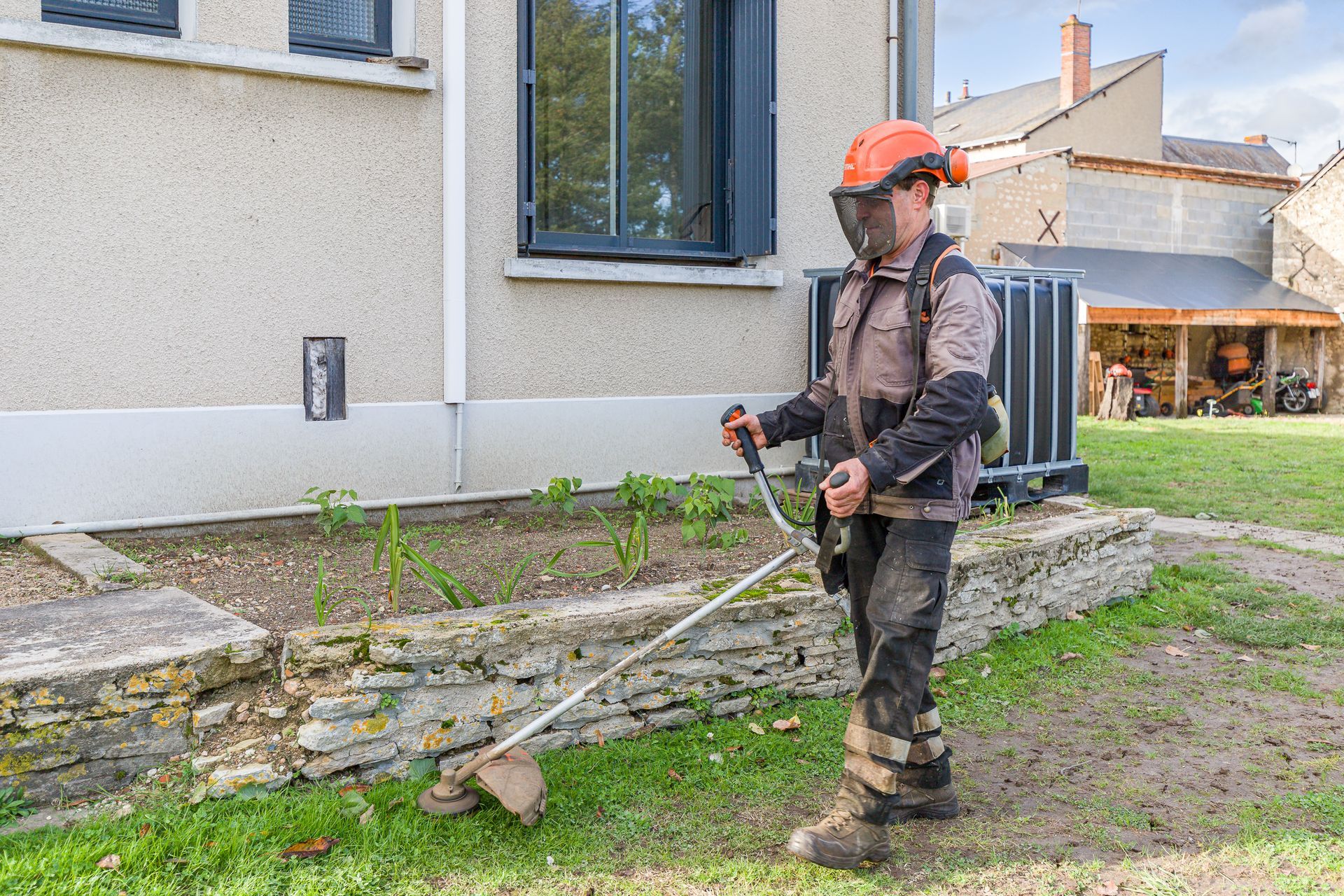 Professionnel d'EMPLOI PLURI-SERVICES taillant une pelouse