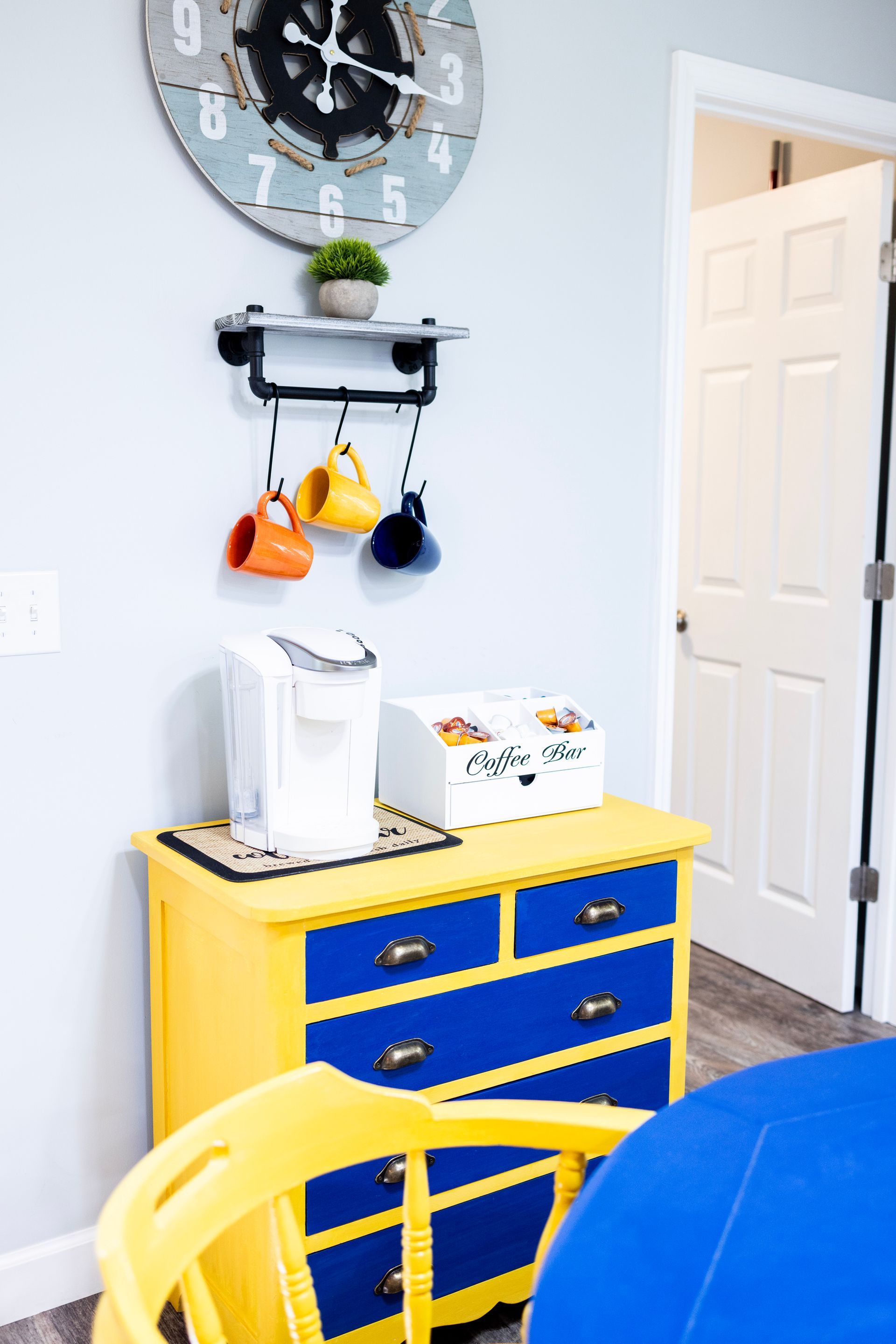 There is a clock on the wall above the dresser.