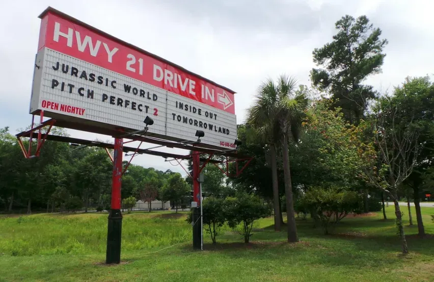A billboard that says hwy 21 drive in jurassic world pitch perfect 2