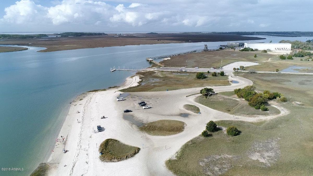 An aerial view of a beach next to a body of water.
