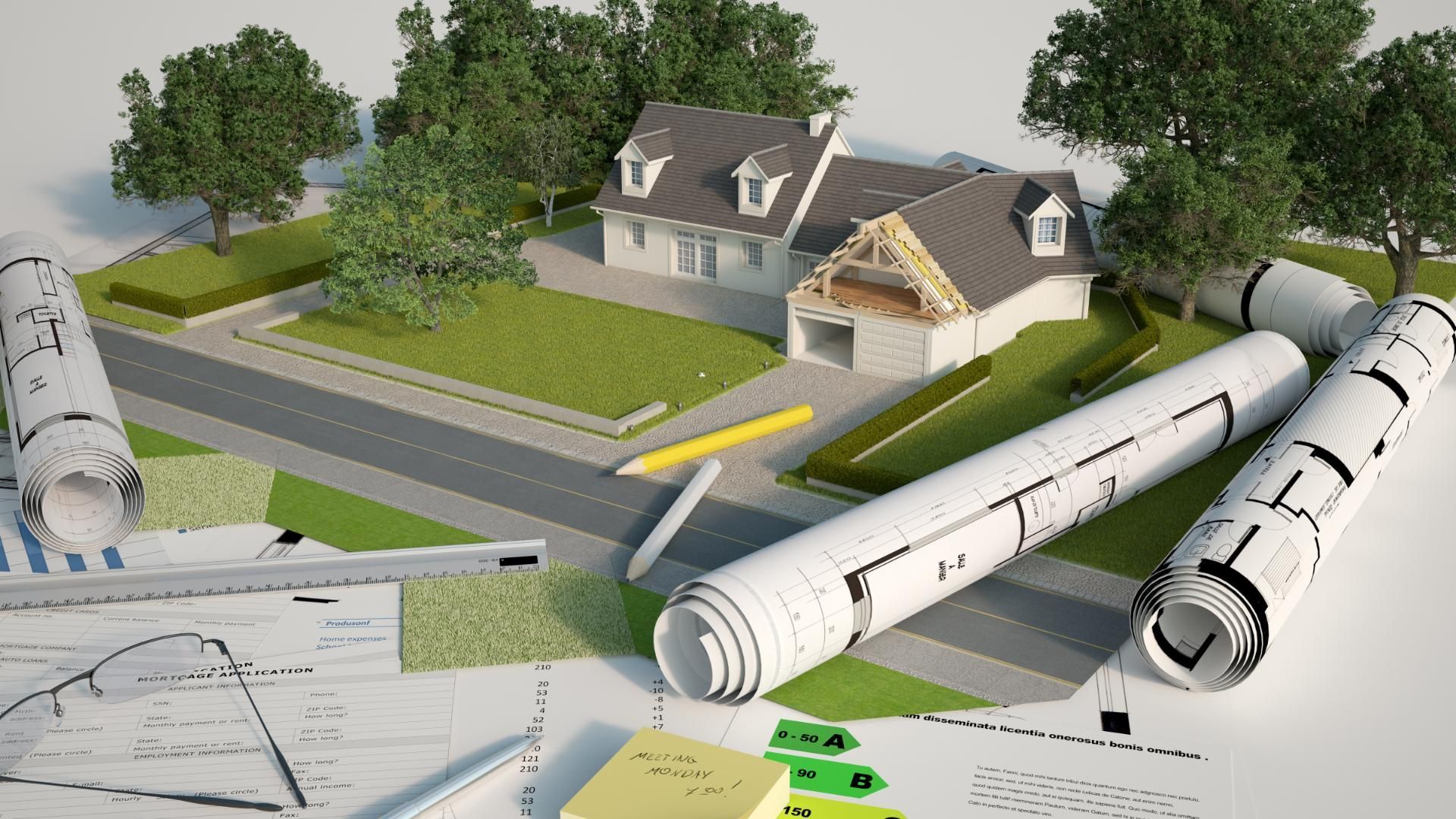 Ein Hausmodell ist von Bauplänen und Bäumen umgeben.