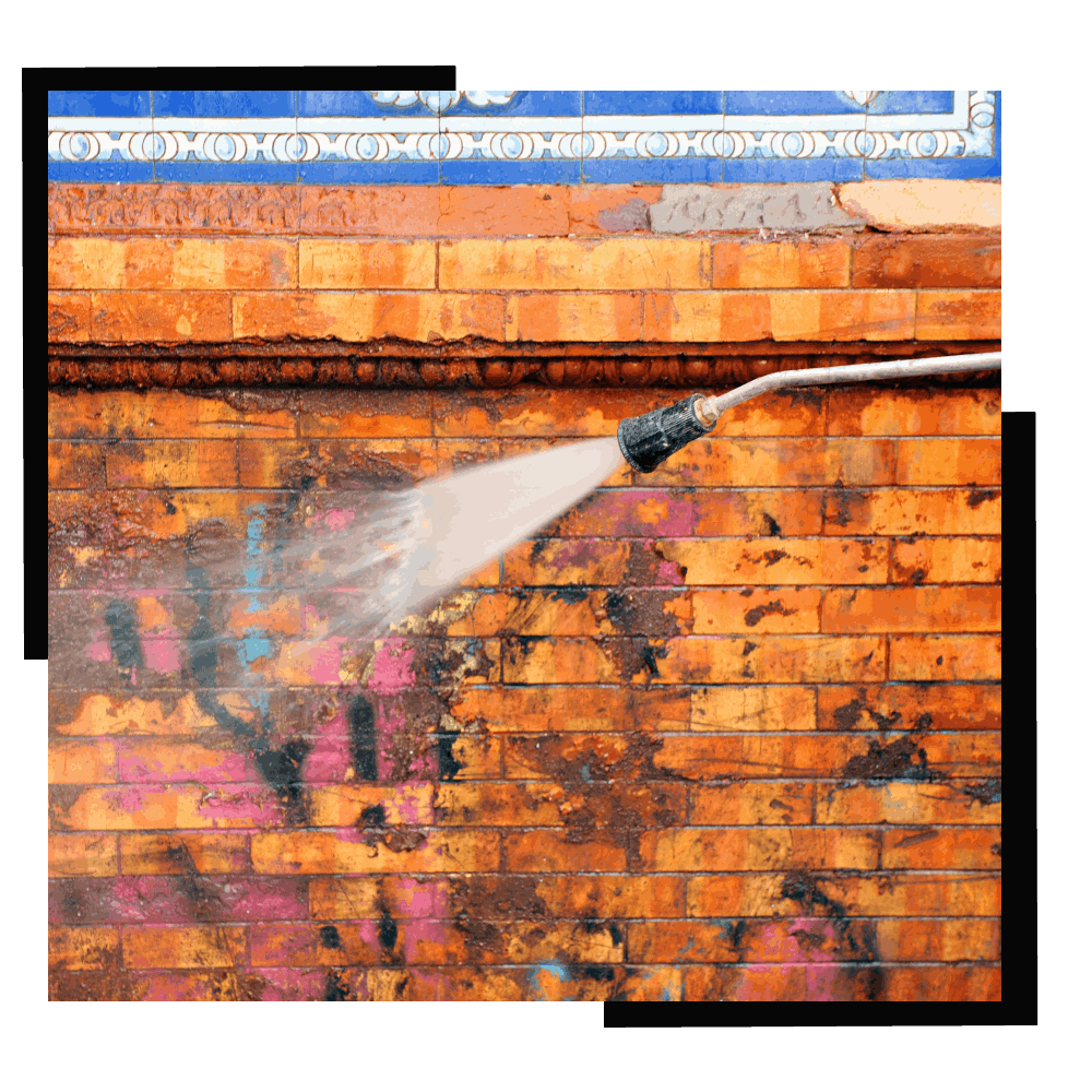 Person im Schutzanzug reinigt eine Edelstahloberfläche im Labor.