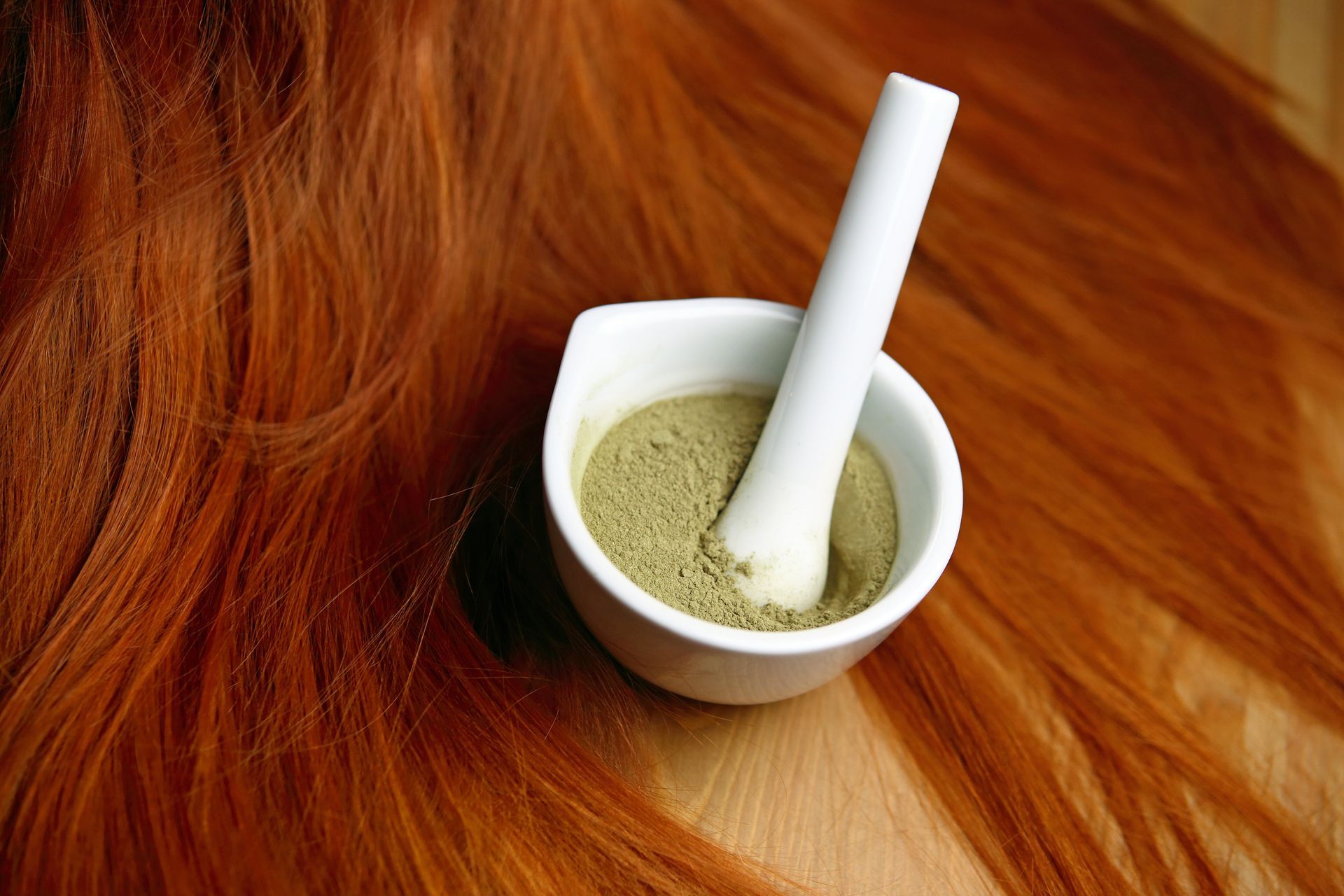 Bol de henné en poudre sur des cheveux roux