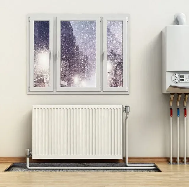 Una habitación con radiador, ventana y caldera.