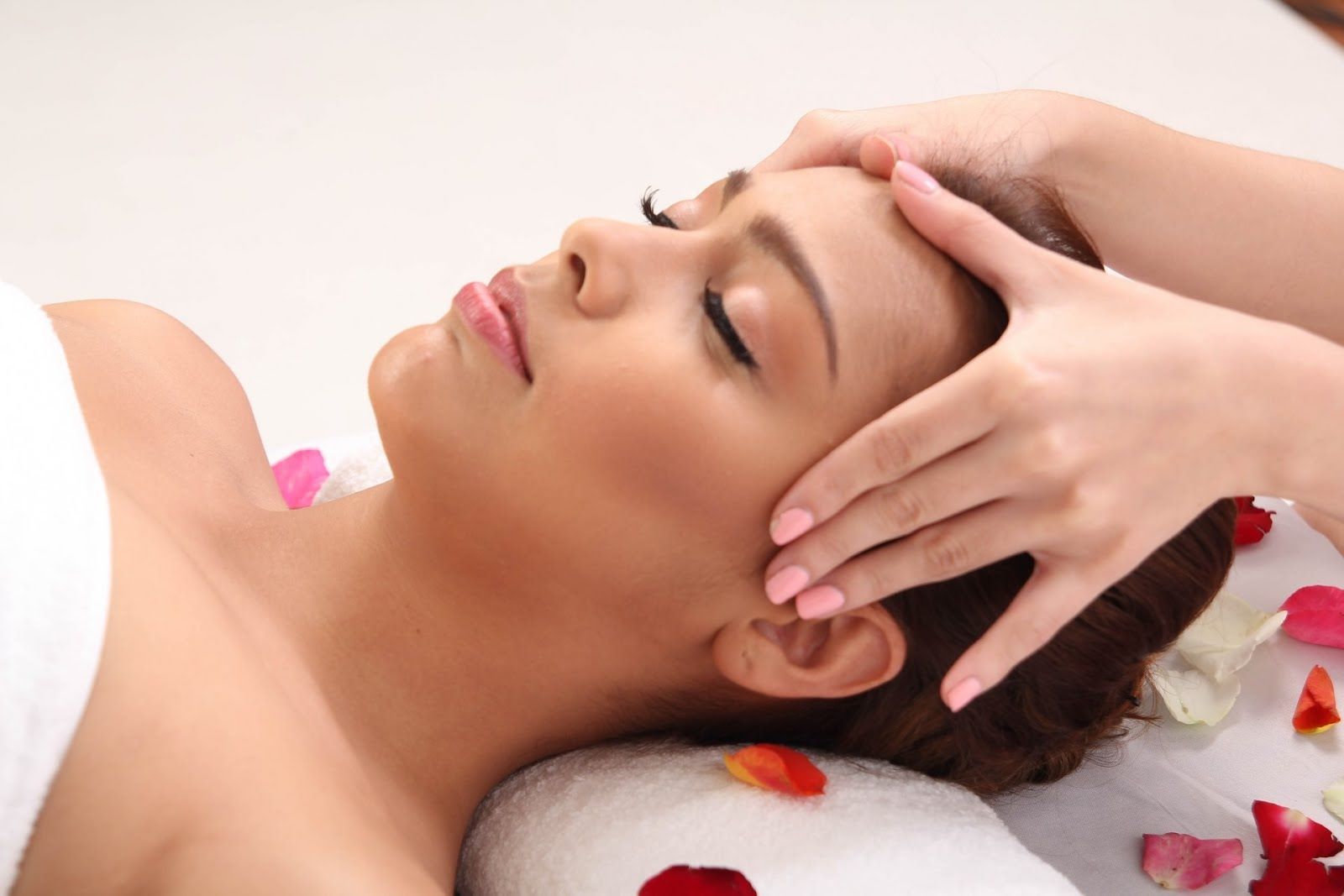 Intérieur d'une pièce de type spa avec un comptoir blanc, un canapé et un grand miroir sur le mur.