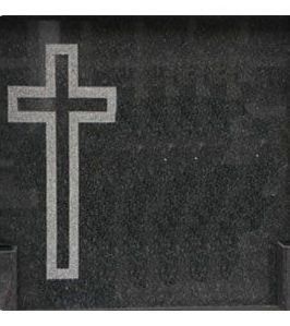 Una cruz está tallada en una losa de granito negro.
