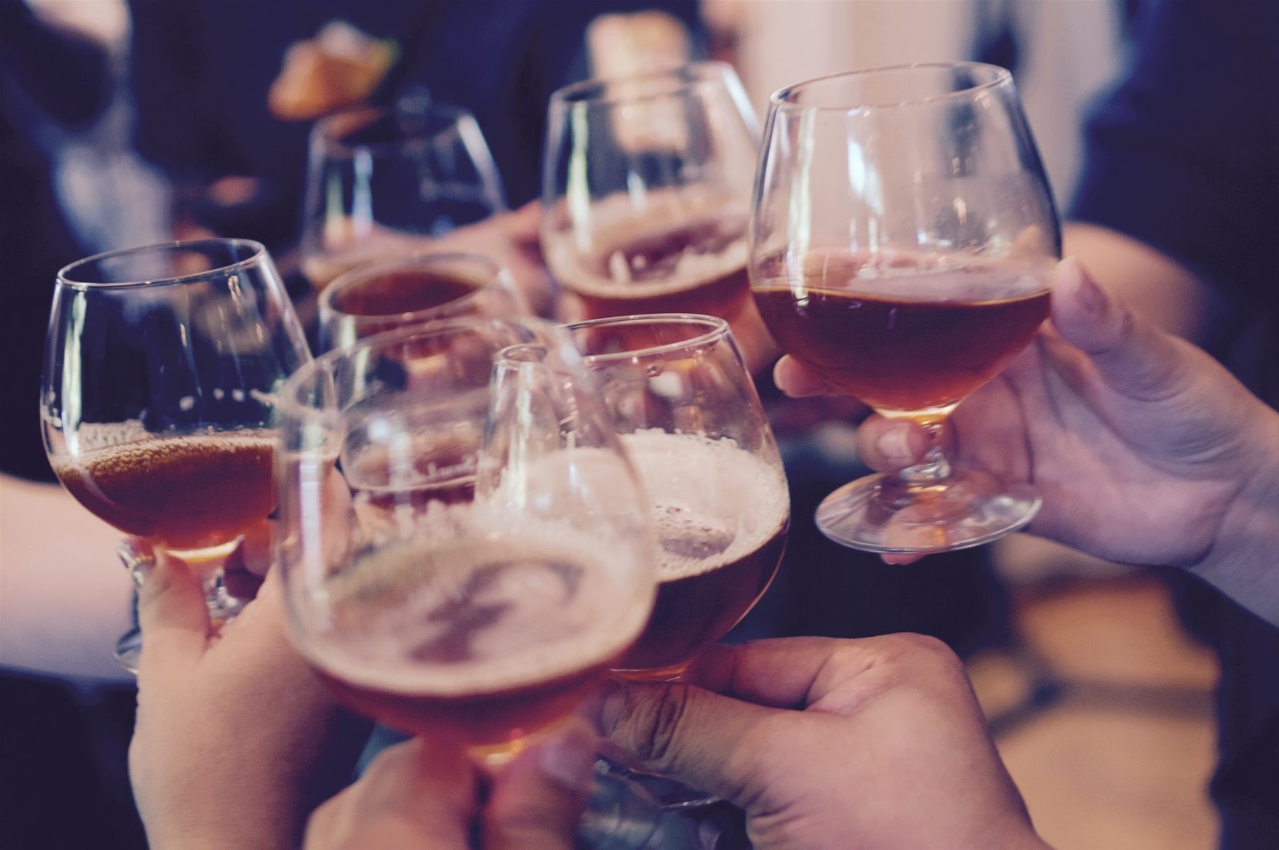 Hands toasting with glasses of beer.