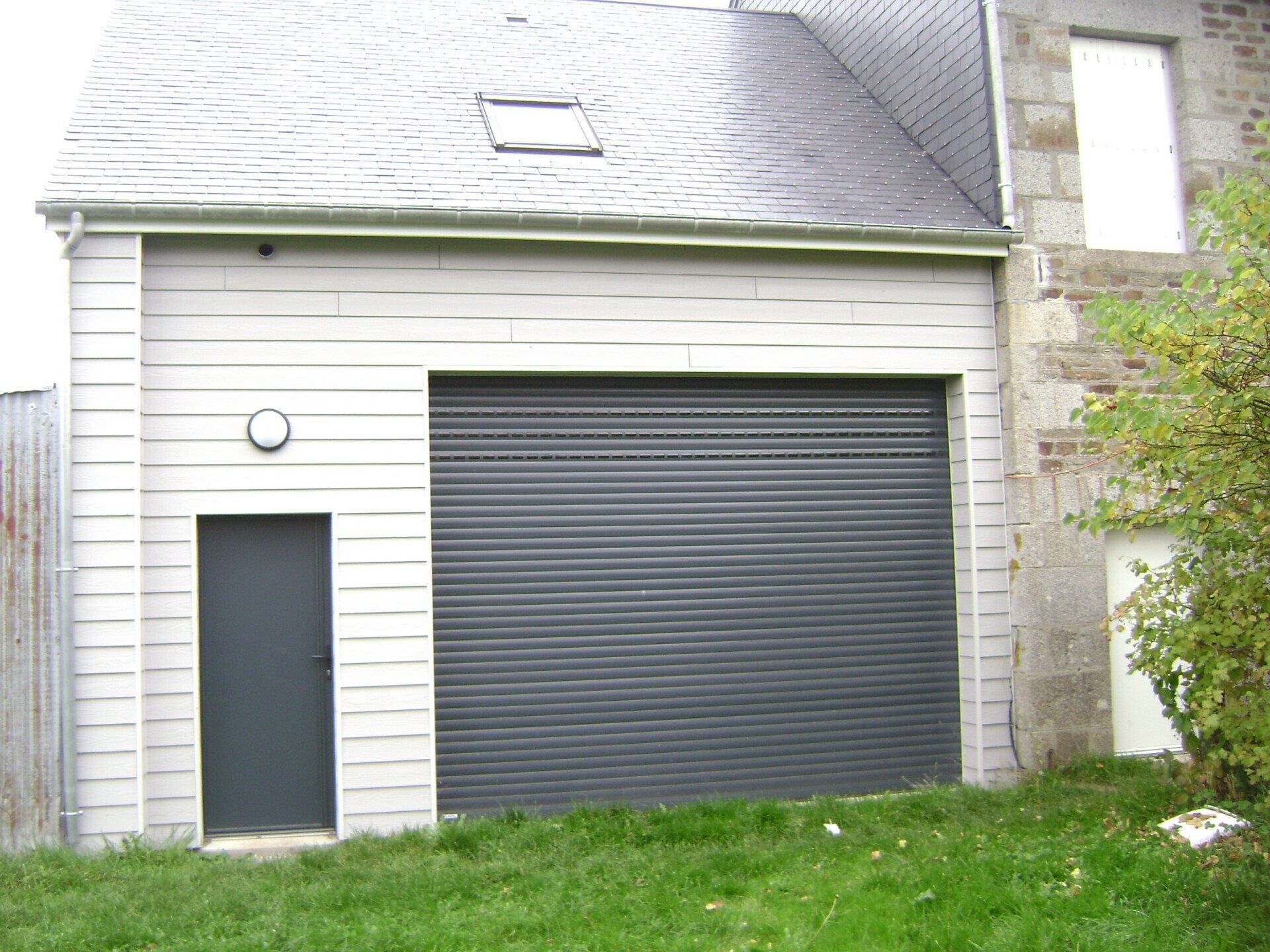 Porte de garage enroulable avec porte d'entrée à côté