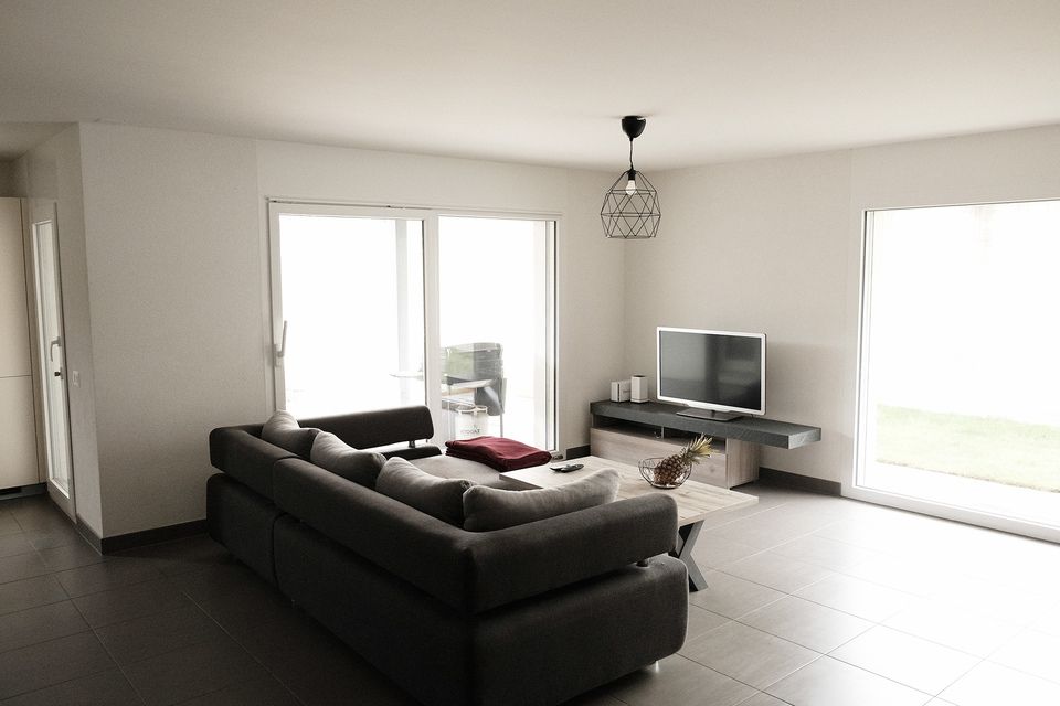 Un salon avec un canapé et une télévision à écran plat