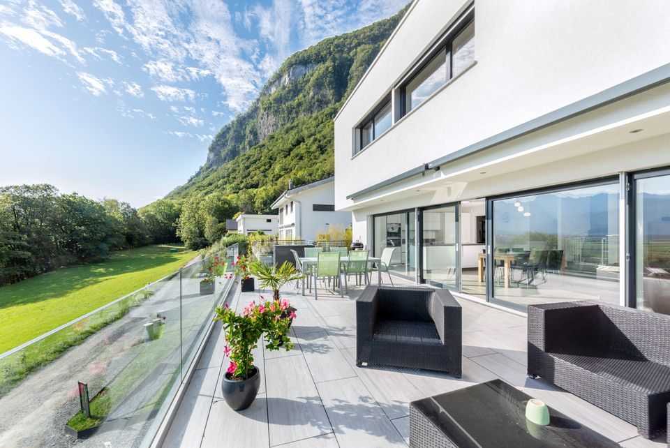 Il y a un grand balcon avec vue sur les montagnes.