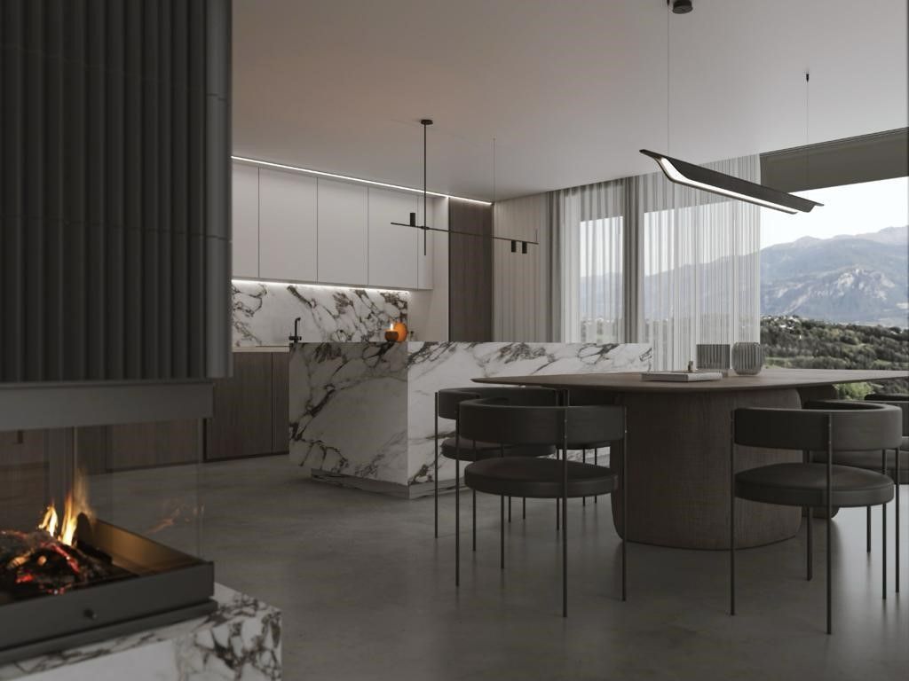 Cuisine moderne avec îlot en marbre, table à manger avec chaises, cheminée et vue sur la montagne.