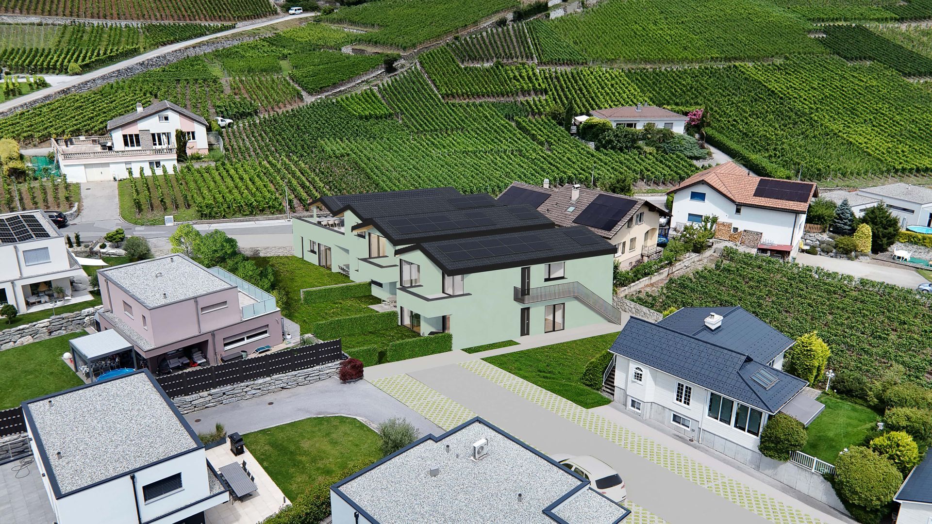 Maisons en milieu rural, avec des vignes à flanc de colline en arrière-plan. Toits verts et gris.