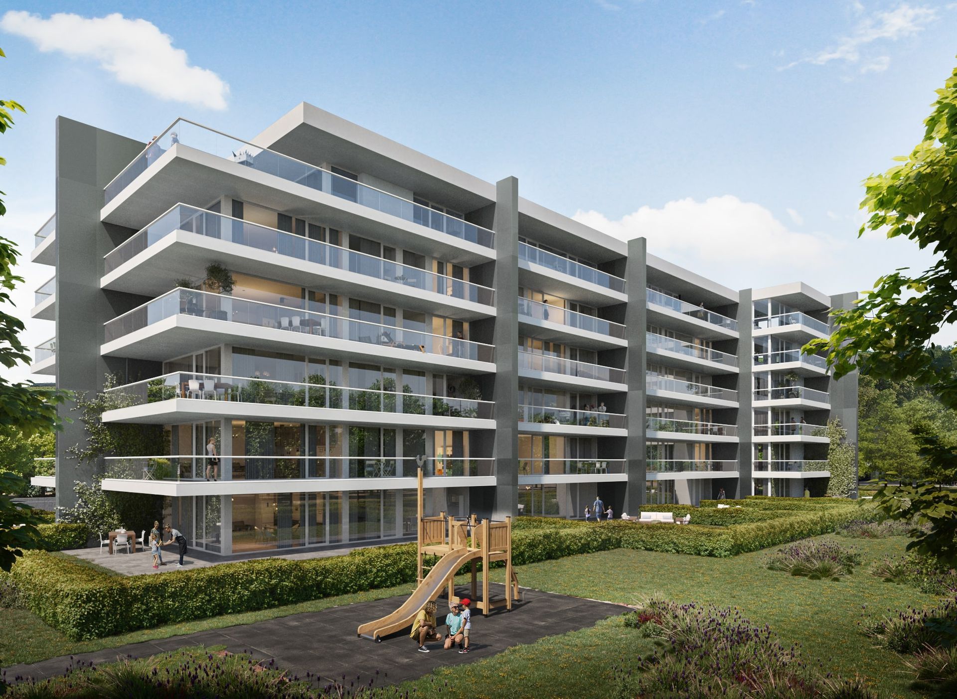 Immeuble d'appartements moderne avec balcons, aire de jeux et aménagement paysager.