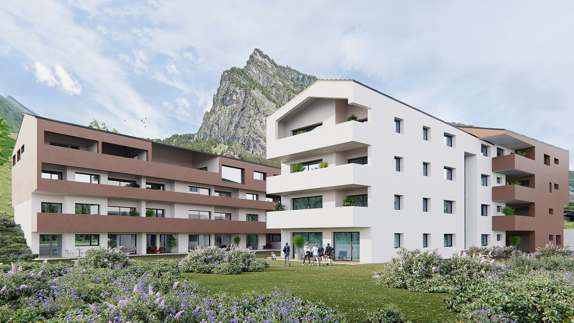 Deux immeubles d'appartements modernes avec la montagne en arrière-plan.