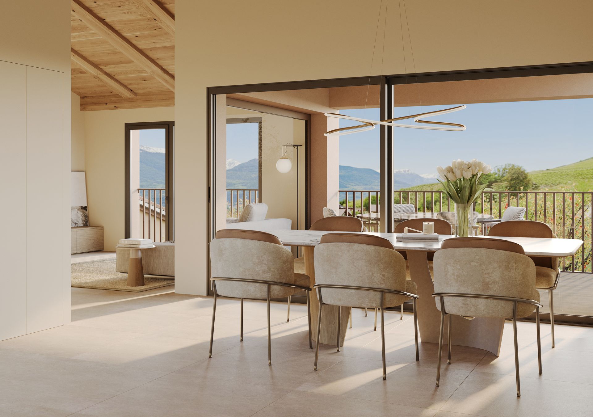 Salle à manger avec table et chaises donnant sur un balcon avec vue sur la montagne.