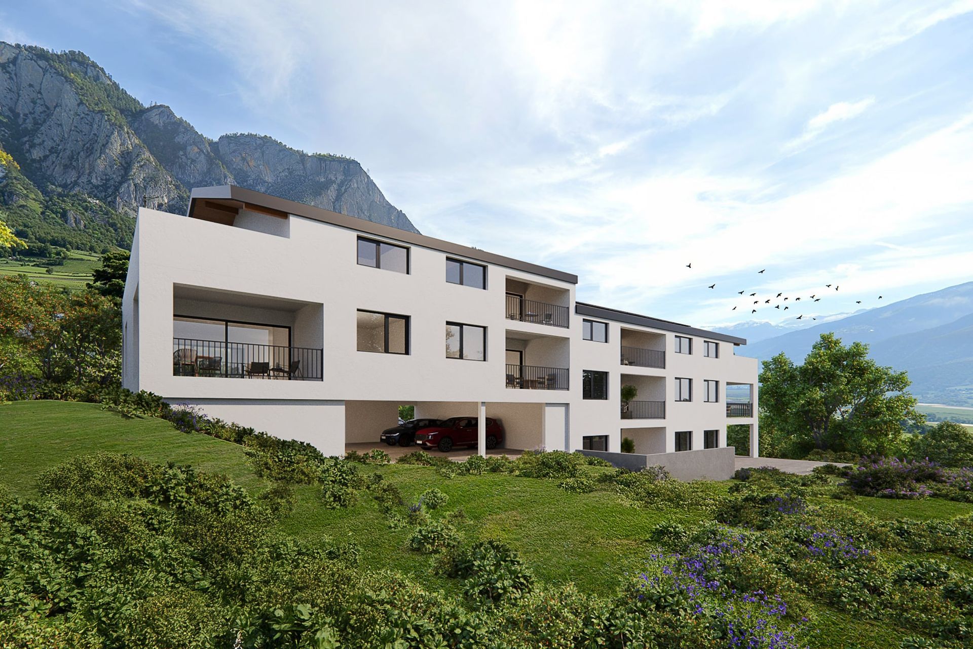Bâtiment blanc moderne avec balcons et vue sur les montagnes.