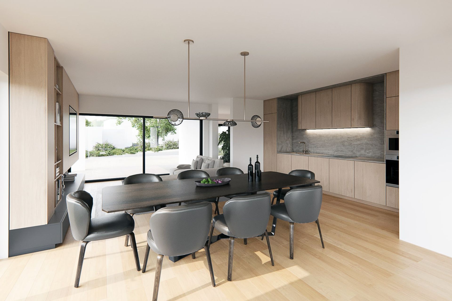 Salle à manger ouverte : table foncée avec chaises grises, cuisine avec armoires en bois.