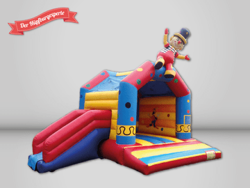 Der Hüpfburgexperte bunte Hüpfburg mit Rutsche, im Clown Design.