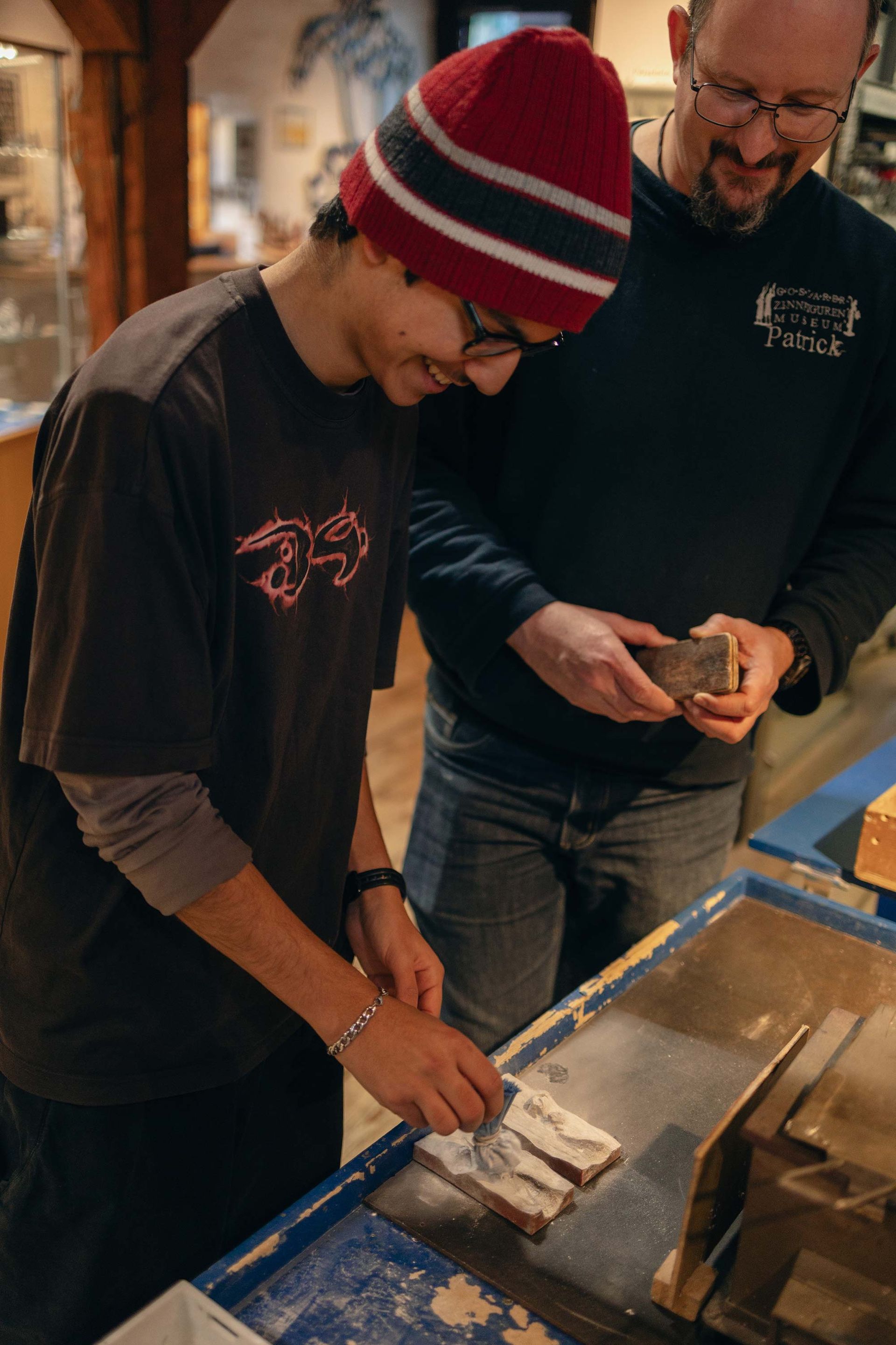 Ein Mann und ein Junge stehen nebeneinander und schauen sich etwas an.