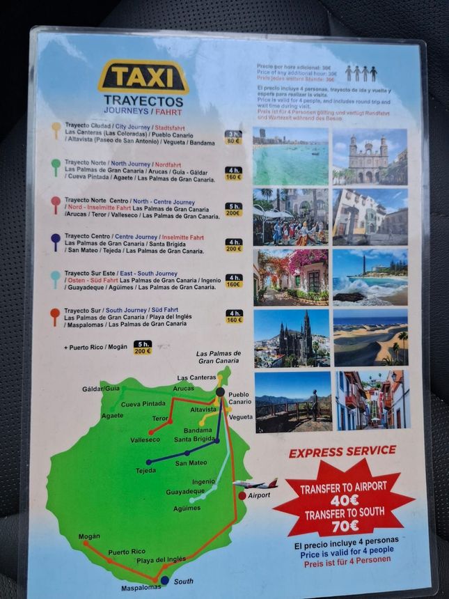 A tall, stone lighthouse rises above a white building with brown trim, set against a blue sky with palm trees and pedestrians.