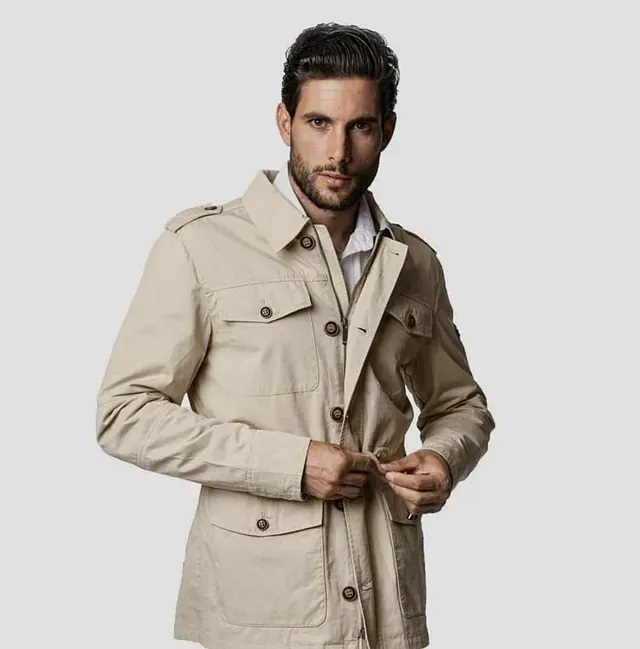 Un hombre con barba lleva una chaqueta color canela.