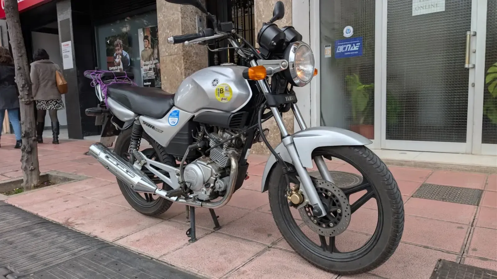 Autoescuela de color blanco estacionado frente al edificio 
