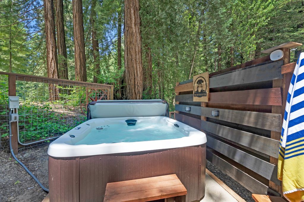 There is a hot tub in the middle of the woods.