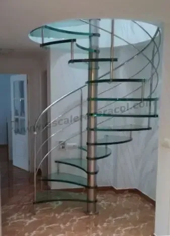Una escalera de caracol de cristal y acero inoxidable.