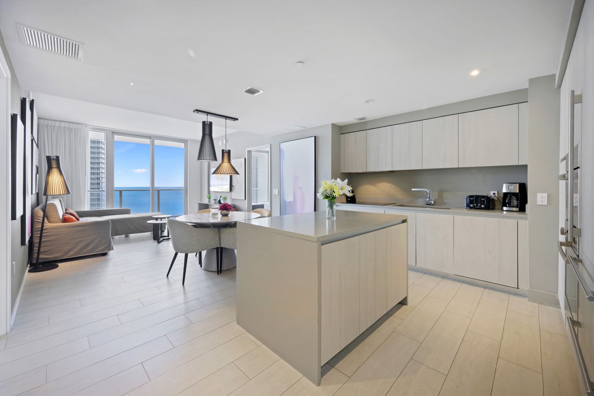 A kitchen with white cabinets and stainless steel appliances