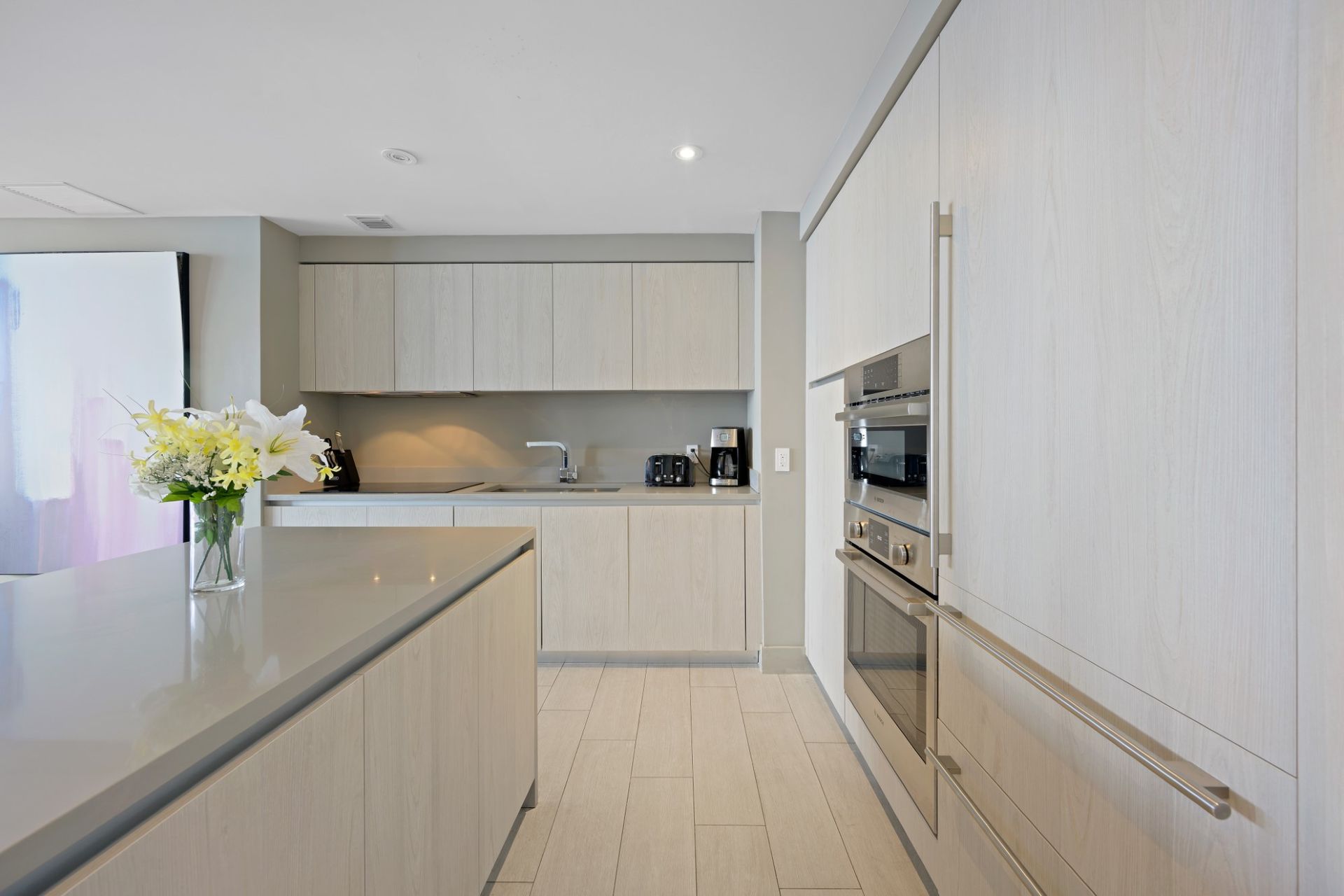A kitchen with white cabinets and stainless steel appliances
