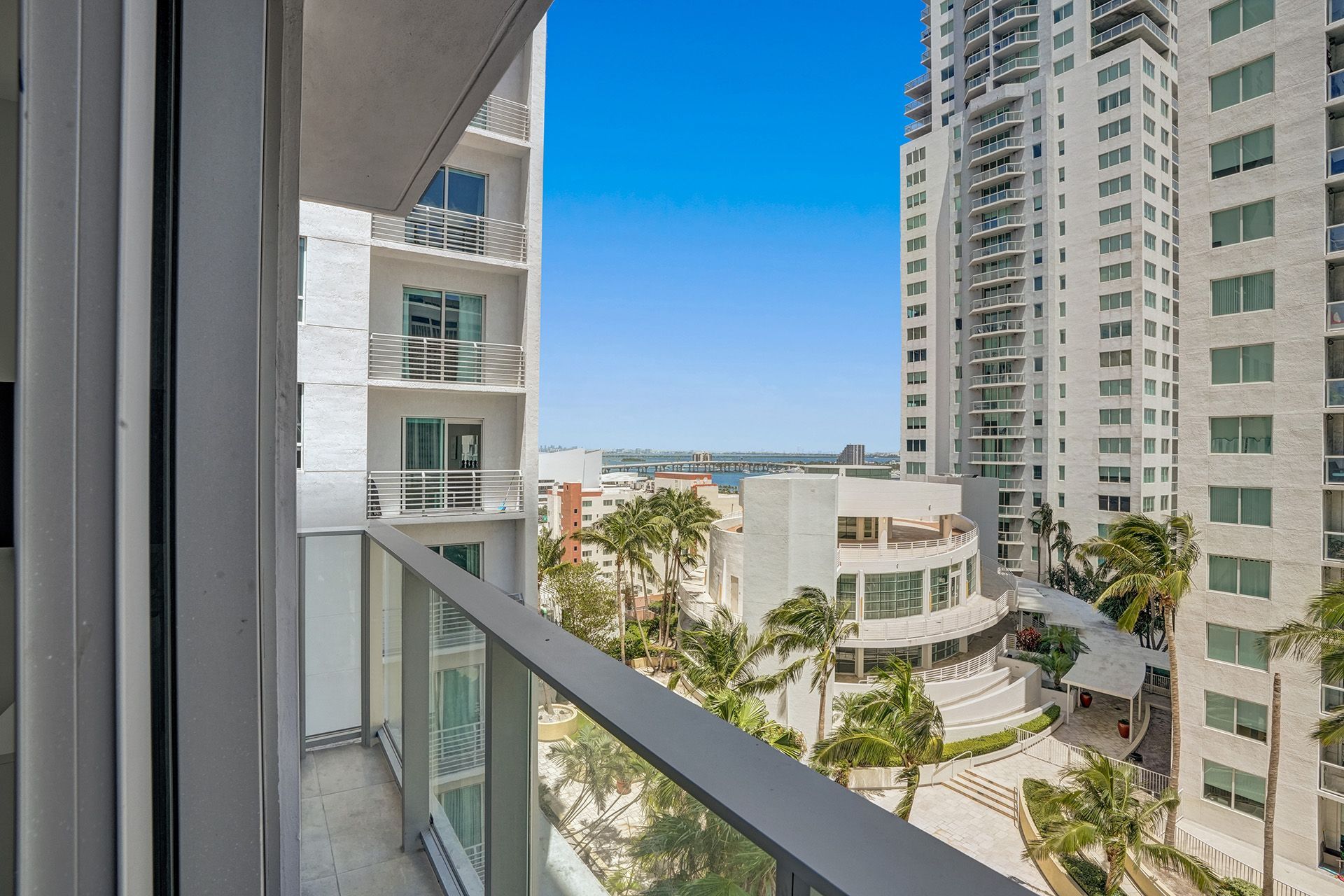 A balcony with a view of a city from a high rise building.