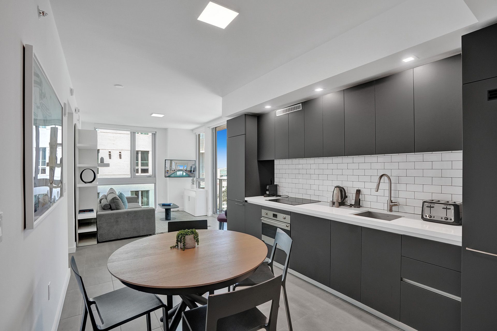 A kitchen with a round table and chairs in it