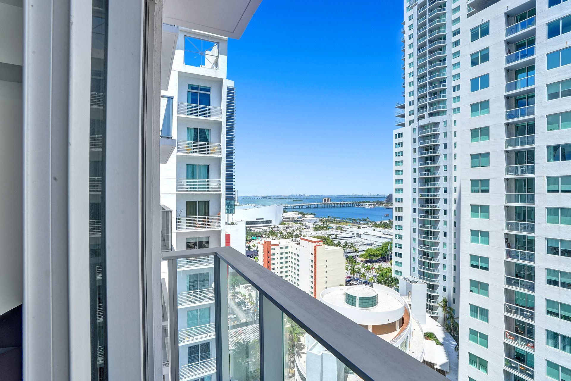 A balcony with a view of a city from a high rise building.